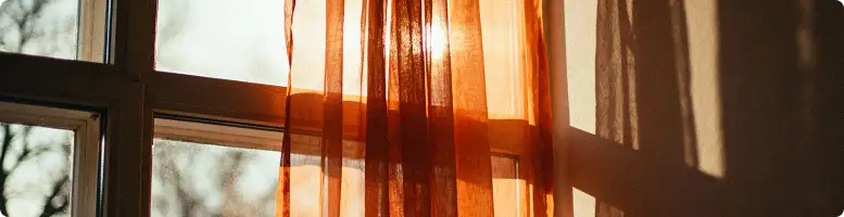 Sunset through sheer curtains