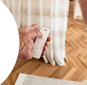 Hand holding motorized curtain remote